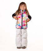 Child wearing multi colored abstract print vest with black accents on a white background