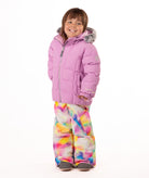 Child wearing a pink quilted puffy winter coat on a white background