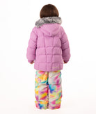 Child wearing a pink quilted puffy winter coat on a white background