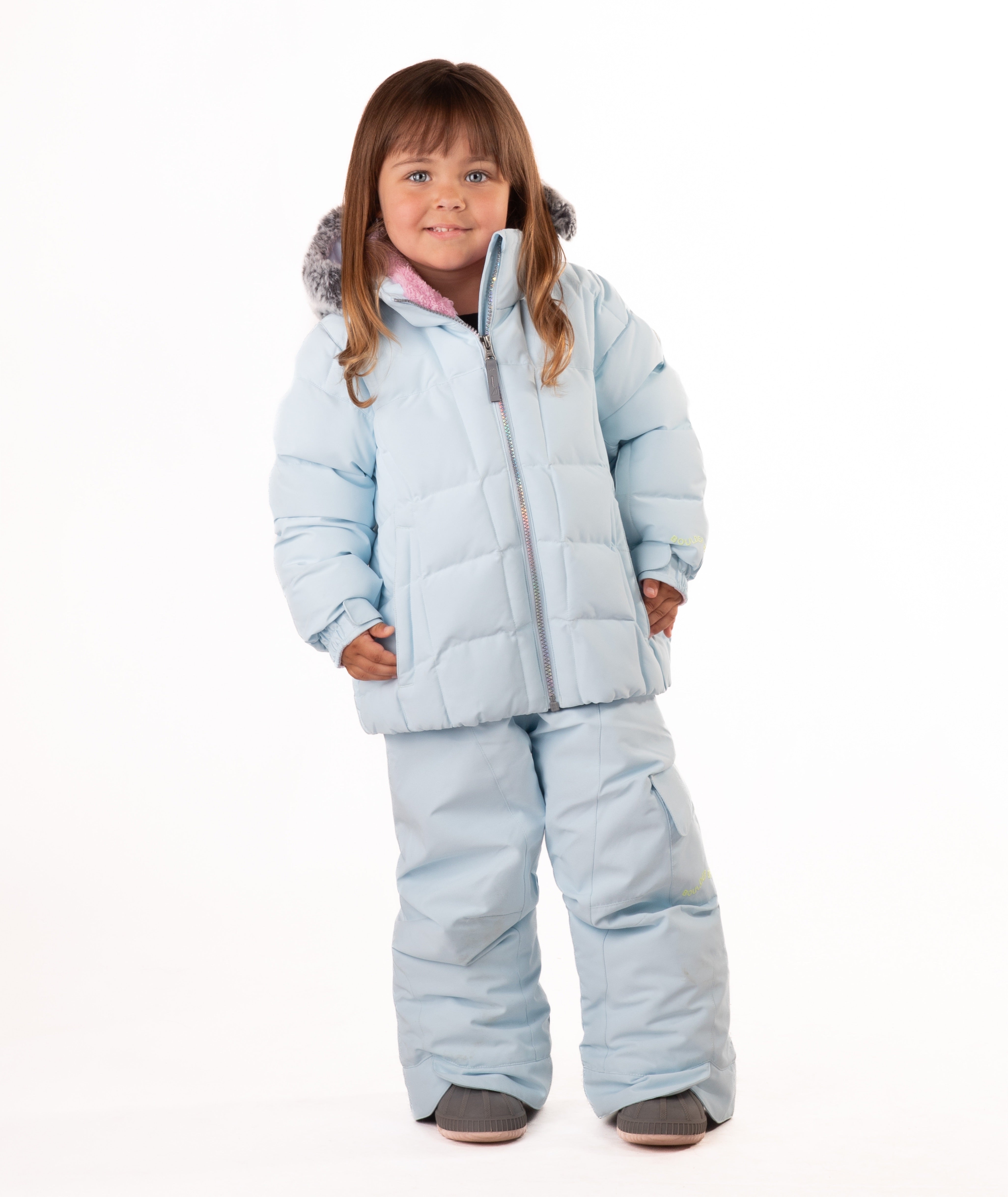 Child wearing a light blue quilted puffy winter coat on a white background