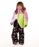 Child wearing a colorful jacket with pink, green, black, and white colors on a white background