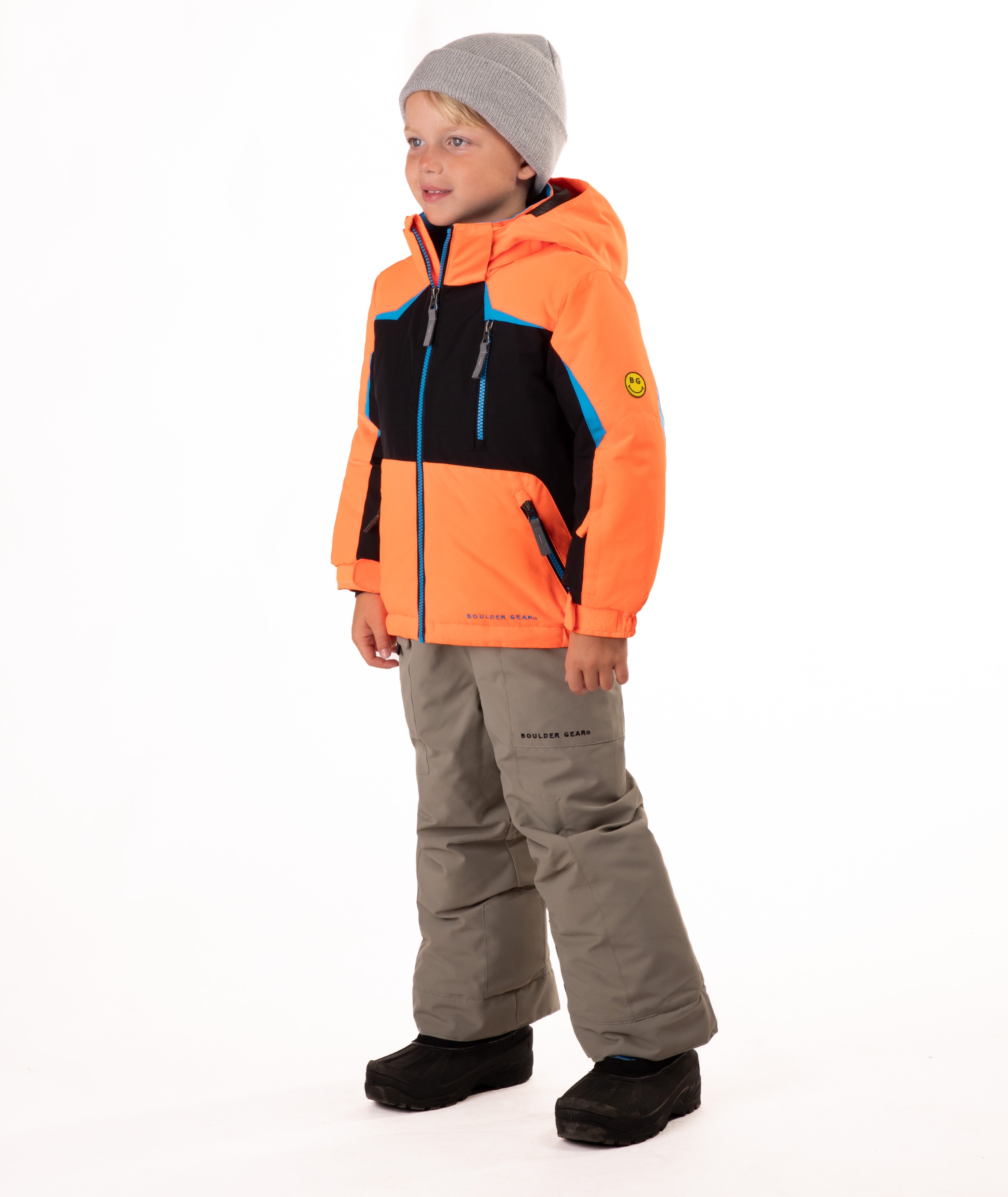 Child wearing an orange and black insulated winter jacket with bright blue trim and a blue center front zipper 