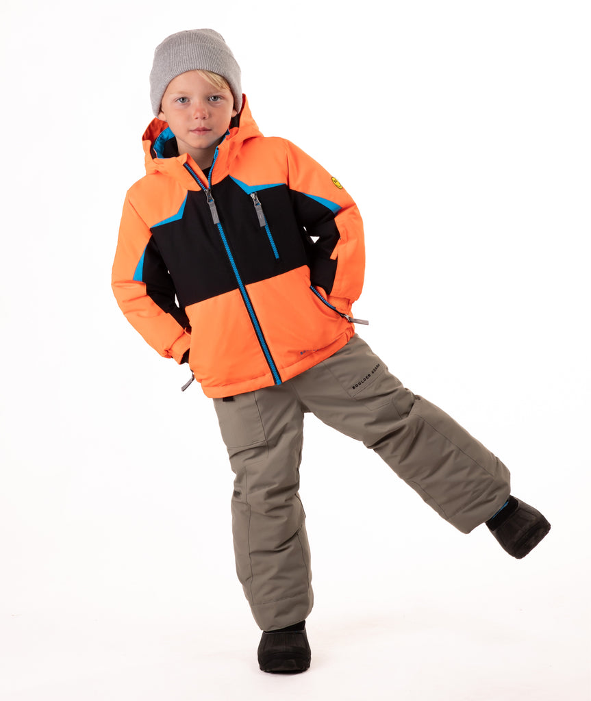 Child wearing an orange and black insulated winter jacket with bright blue trim and a blue center front zipper 