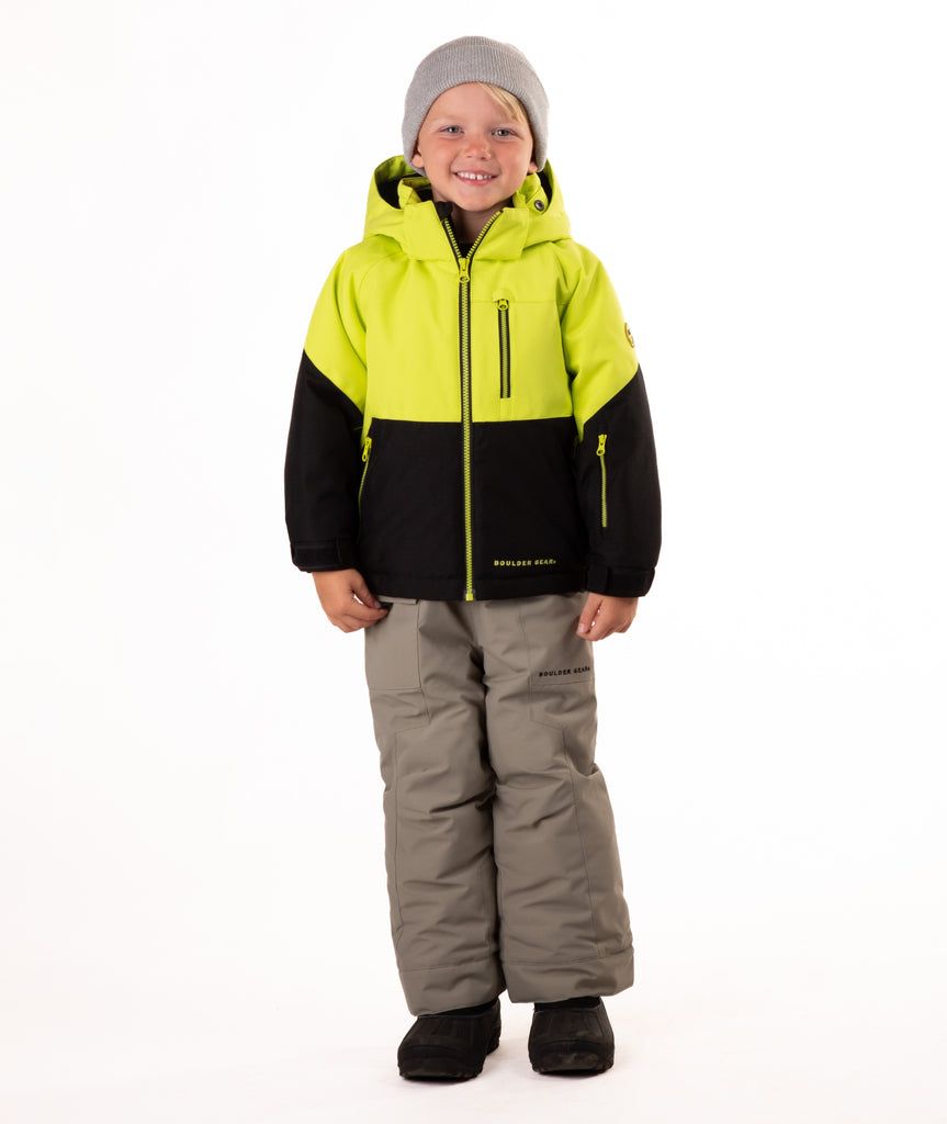 Child wearing a two-tone jacket with black  on the bottom half and bright lime yellow top half on a white background