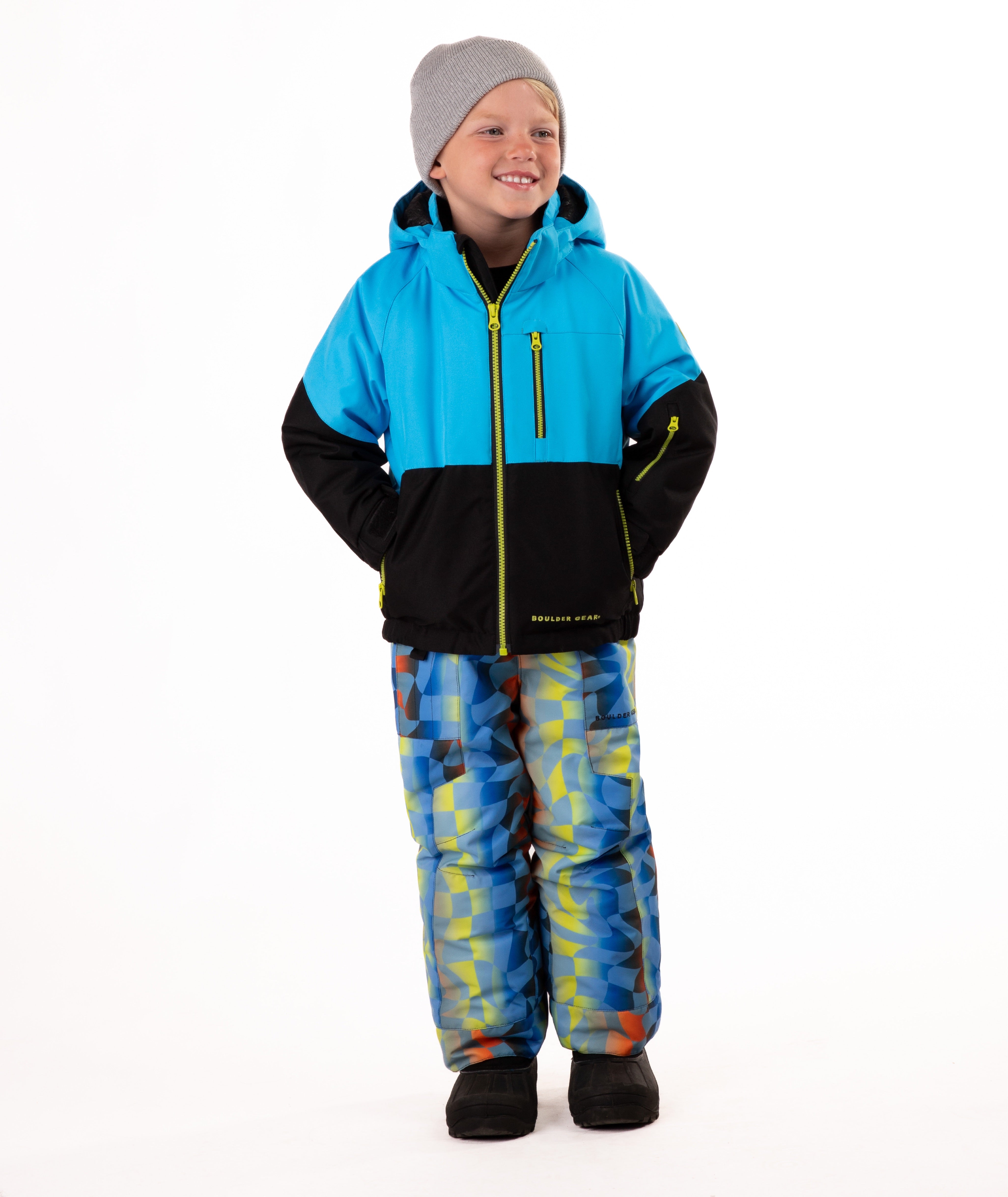 Child wearing a two-tone jacket with blue on the top and black on the bottom of the jacket on white background