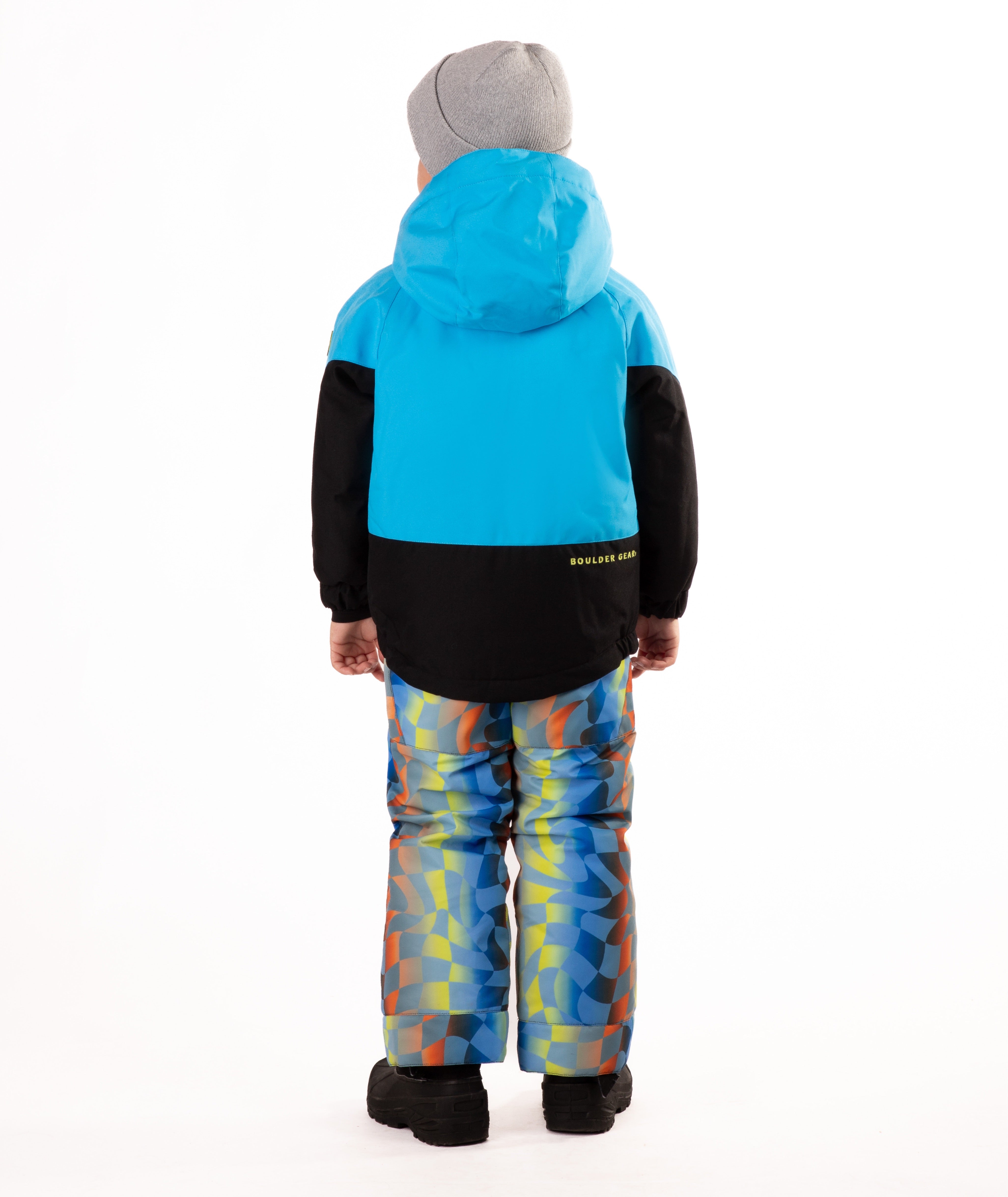 Child wearing a two-tone jacket with blue on the top and black on the bottom of the jacket on white background