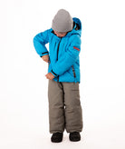 Child wearing a blue quilted winter jacket with chest pockets and hand-warmer pockets on a white background