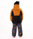 A child wearing a kids' ski jacket and snow pants set against a plain white background. The jacket is a colorblock design in brown and black, paired with blue snow pants featuring a multicolor mountain and ski pattern.