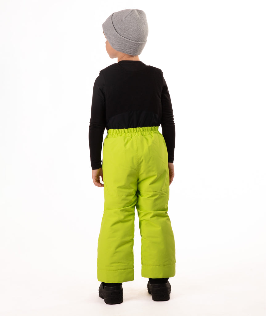 Child wearing kiwi lime snow bibs on a white background
