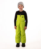 Child wearing kiwi lime snow bibs on a white background