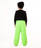 A child wearing bright neon green snow bib overalls over a black long-sleeve shirt and black beanie, standing against a plain white studio background.