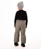 Child wearing beige snow bibs on a white background showing back of bib