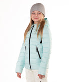 girl wearing a light blue puffer jacket on a white background