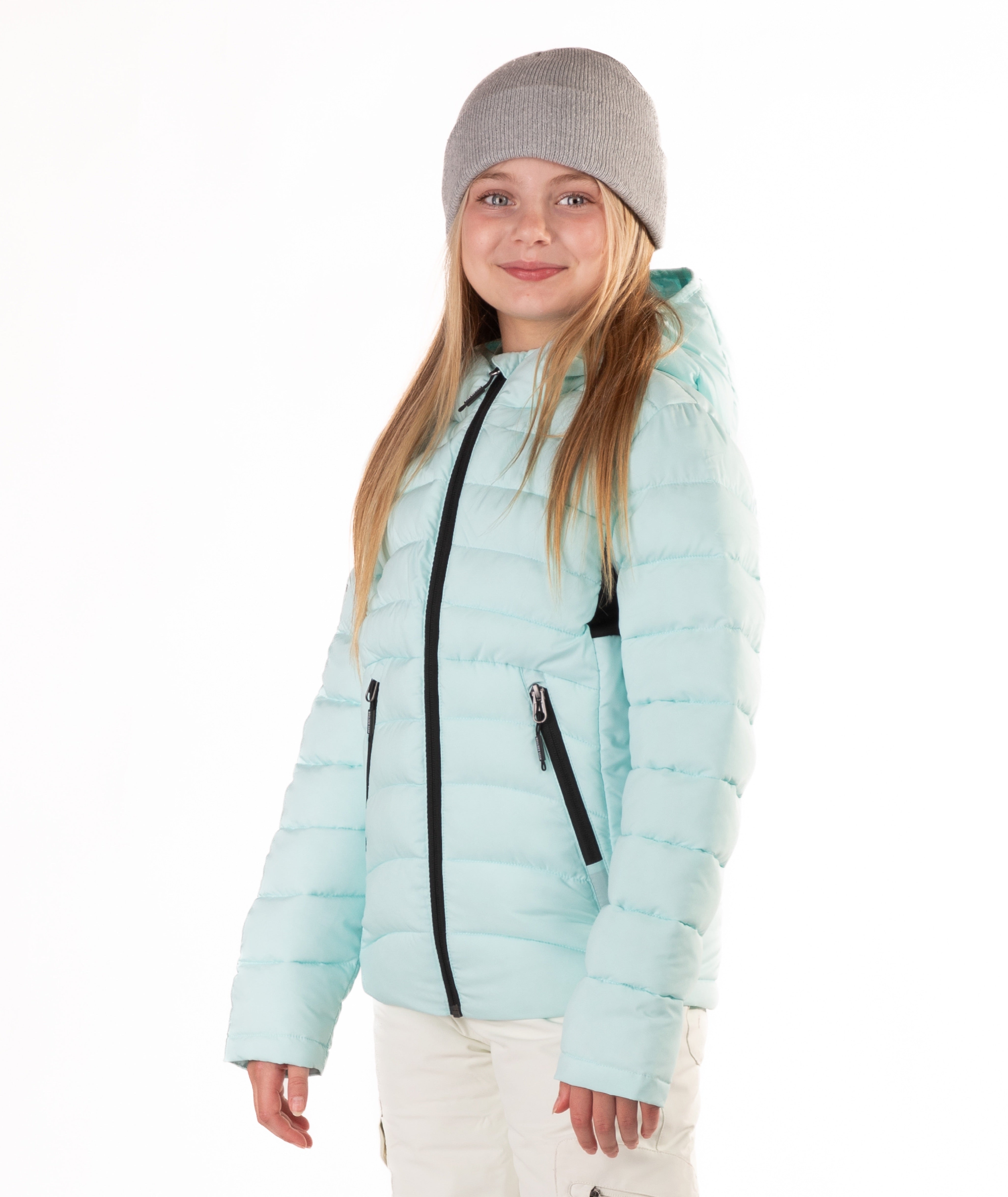 girl wearing a light blue puffer jacket on a white background