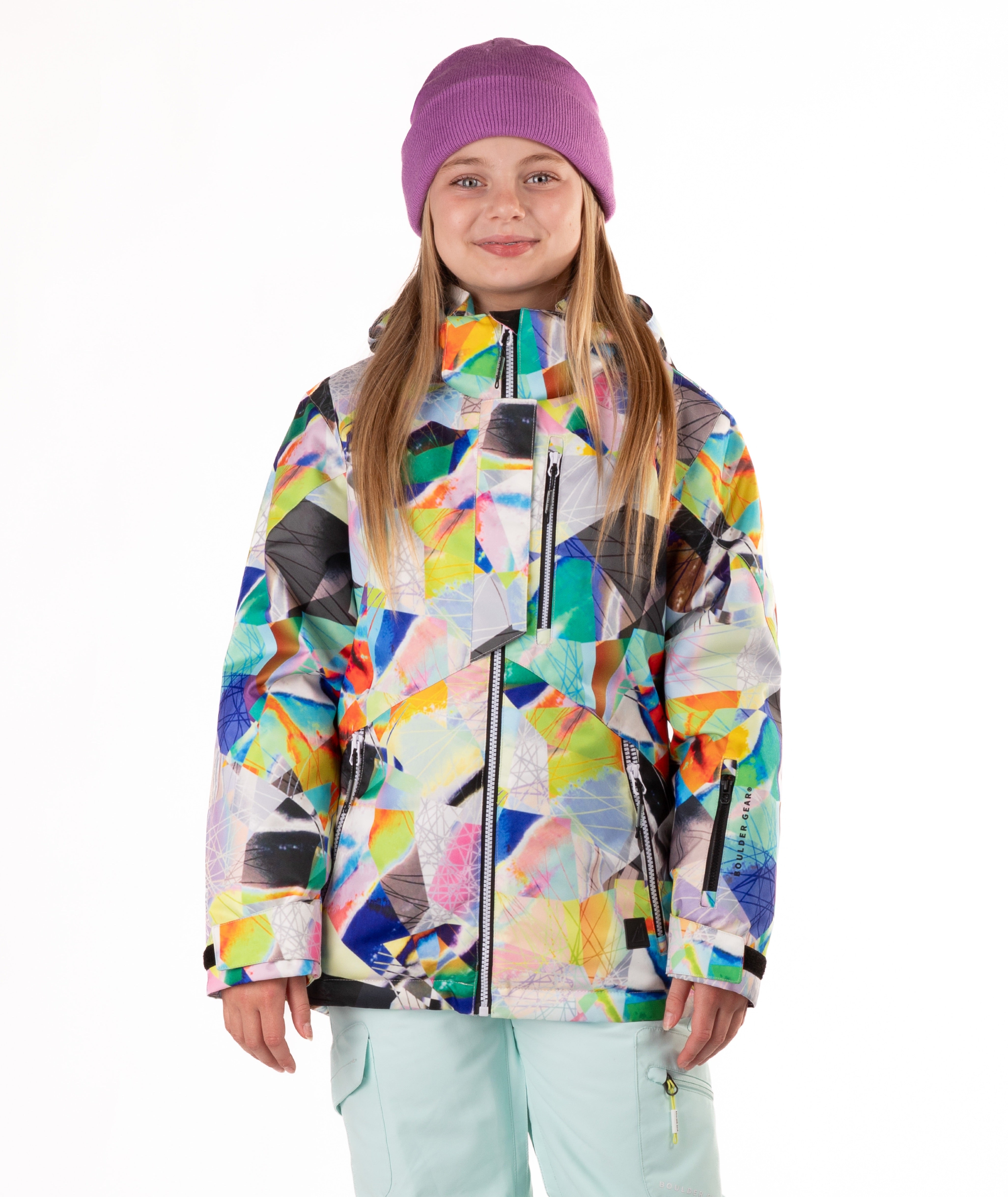 Youth girl wearing a colorful geometric-patterned jacket on a white background