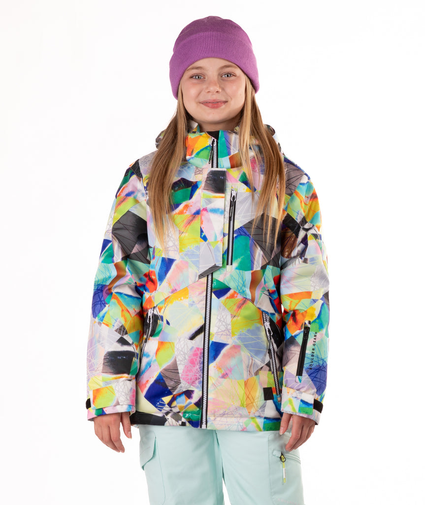 Youth girl wearing a colorful geometric-patterned jacket on a white background