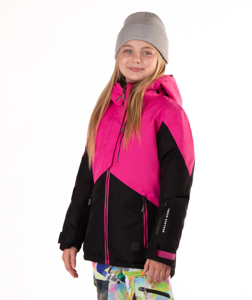 Child wearing a pink and black jacket with contrast zippers on a white background