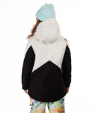 Youth girl wearing a black and white jacket with contrasting zippers on a white background