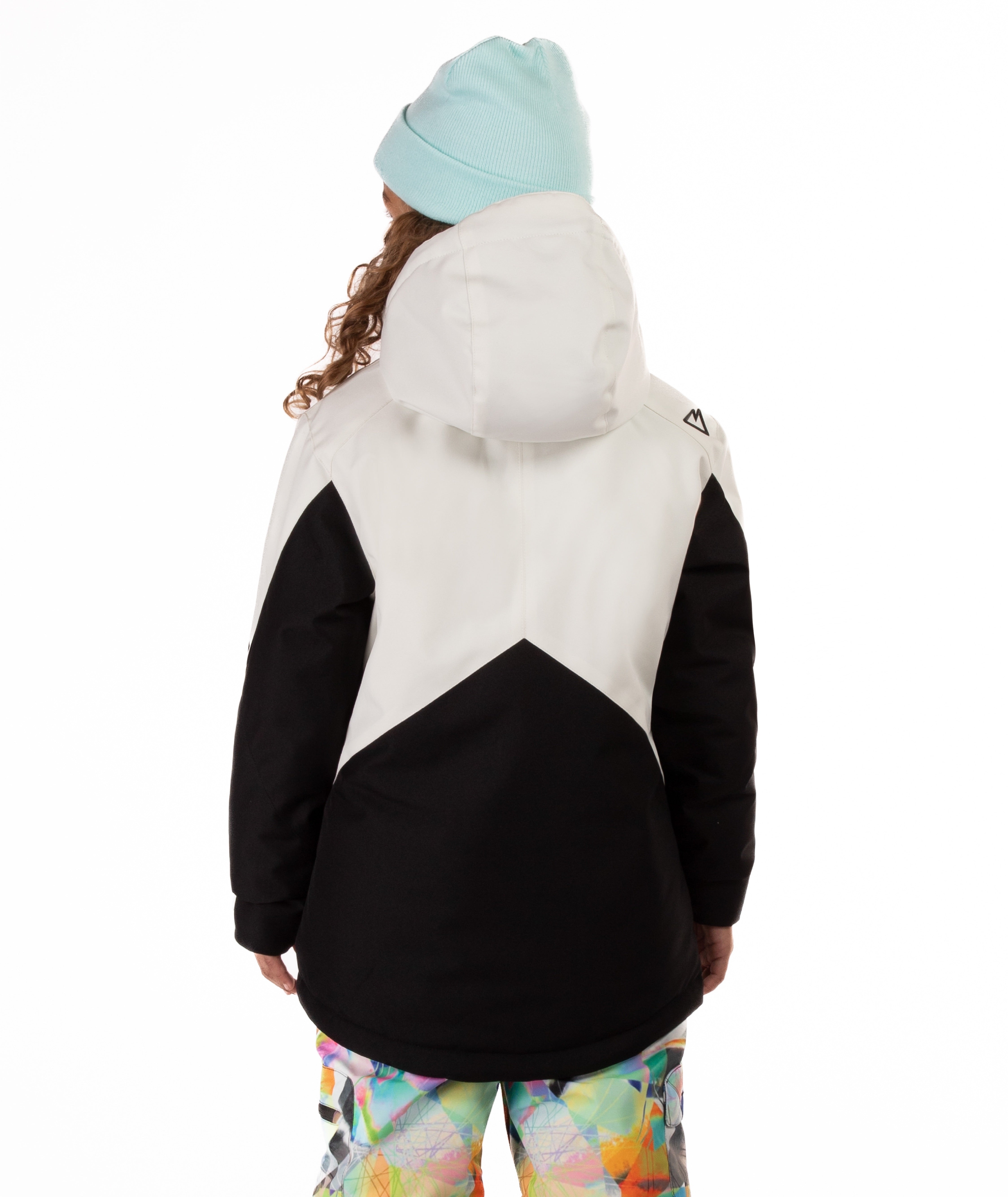 Youth girl wearing a black and white jacket with contrasting zippers on a white background