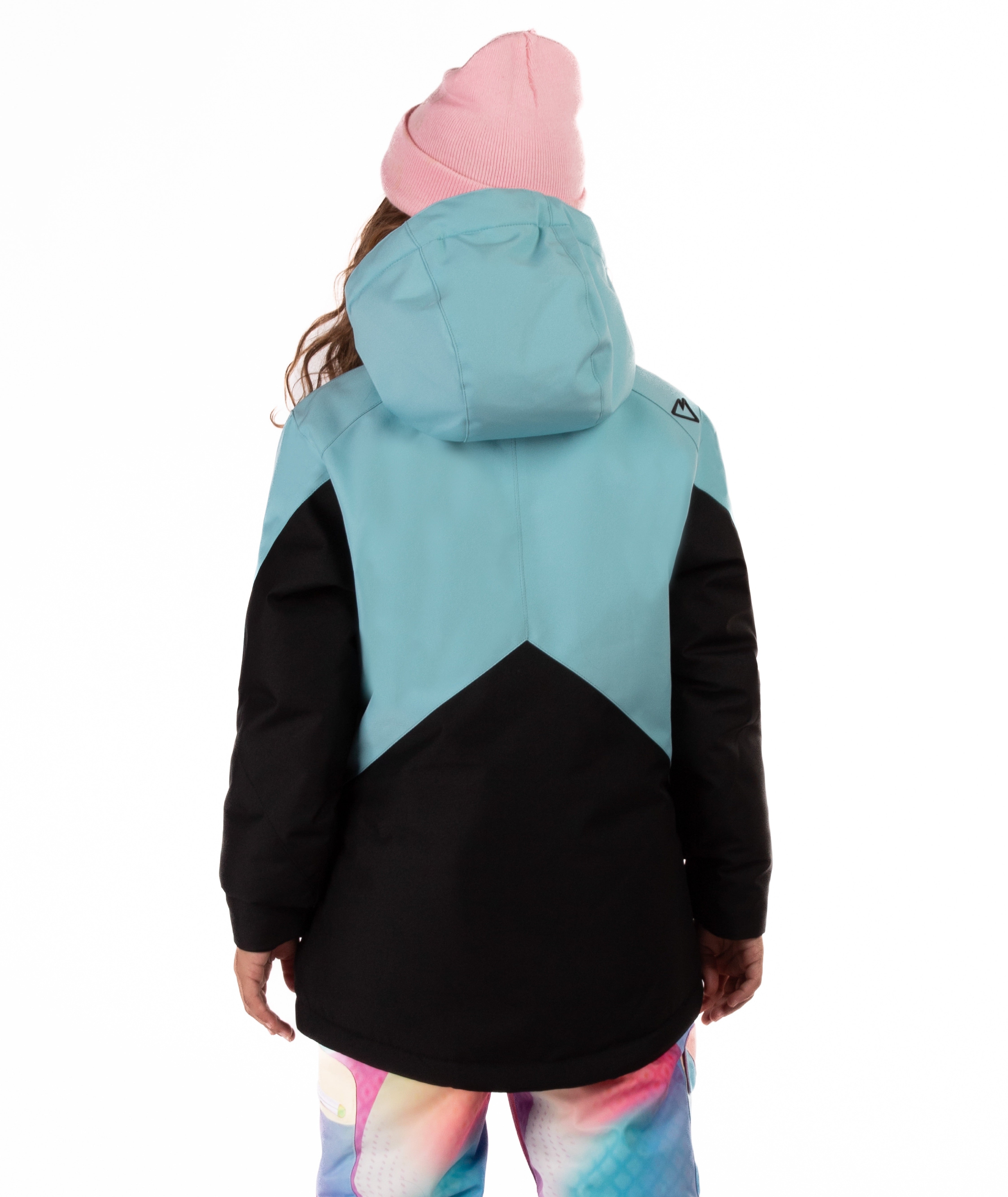Youth girl wearing a teal and black jacket with contrast zippers on a white background