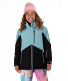 Youth girl wearing a teal and black jacket with contrast zippers on a white background