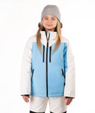 A young girl wearing a light blue and off white color-blocked ski jacket, a gray beanie, and off white ski pants, standing against a solid white background.