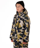 Youth Boy wearing a camouflage-patterned winter jacket on a white background