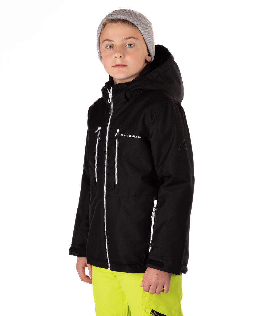 Youth boy wearing a black jacket with white zippers and a Boulder Gear brand logo on a white background