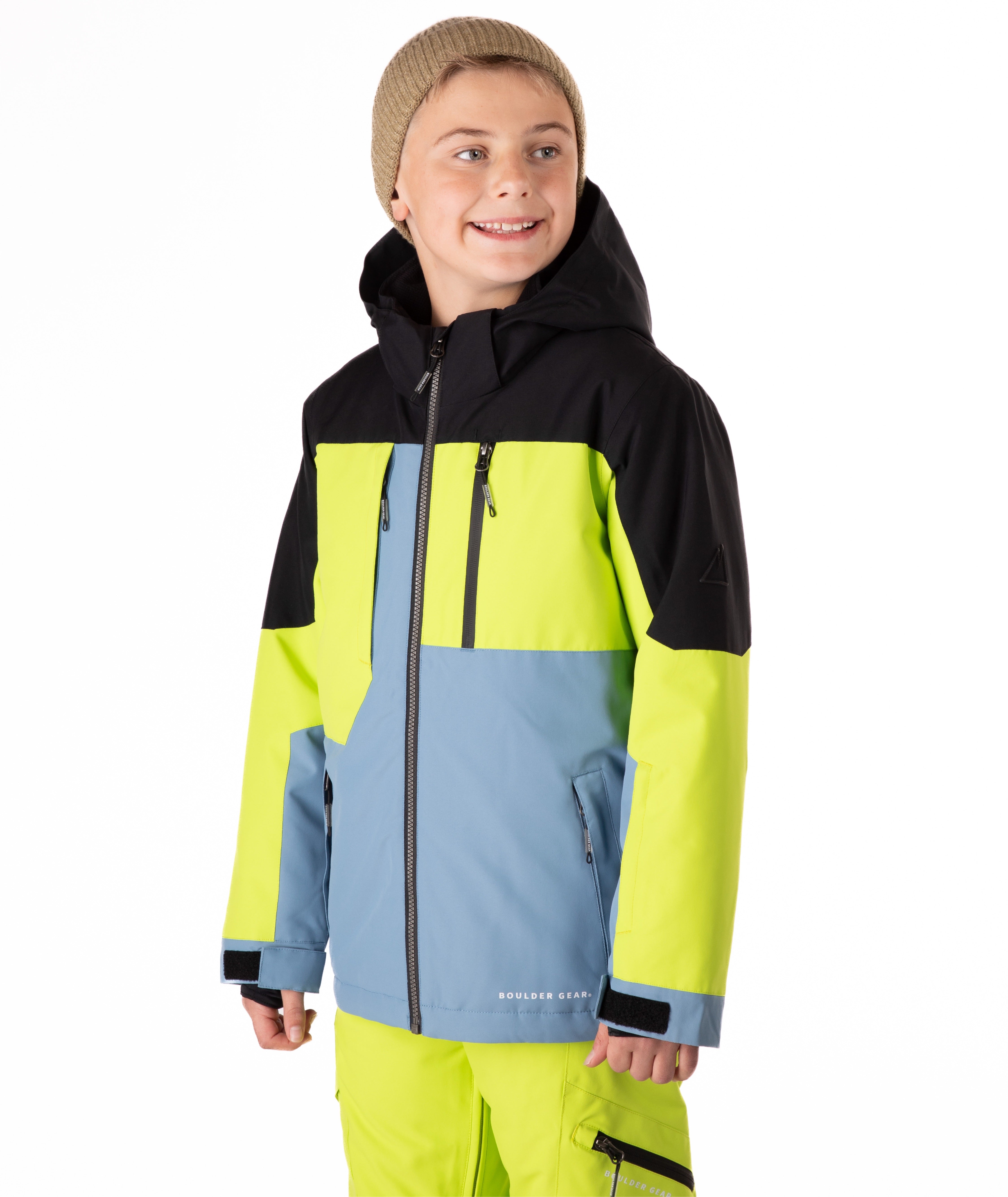 Youth boy wearing a colorful jacket with black, yellow, and blue sections on a white background