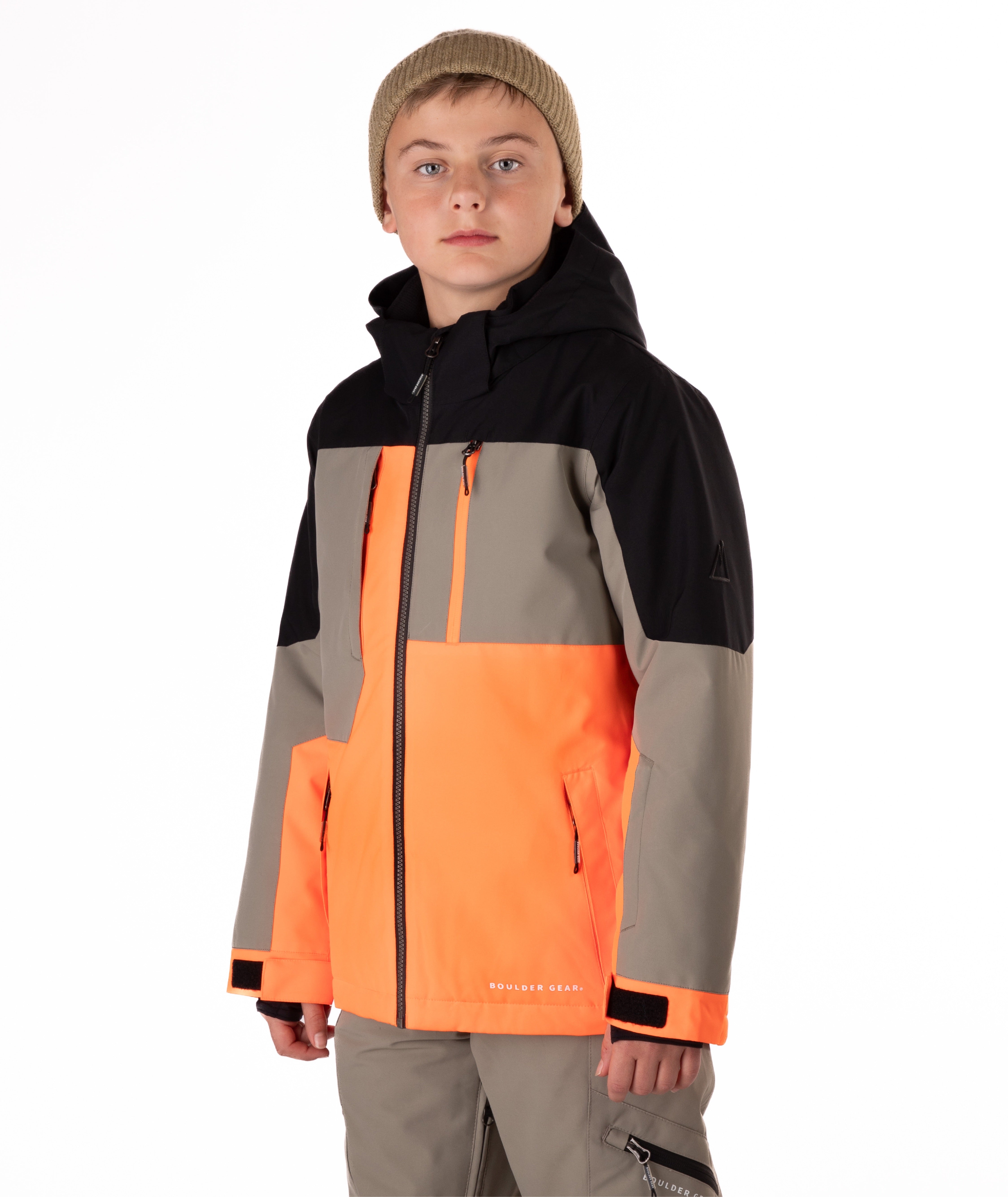 Youth boy wearing a colorful jacket with black, orange, and gray sections on a white background