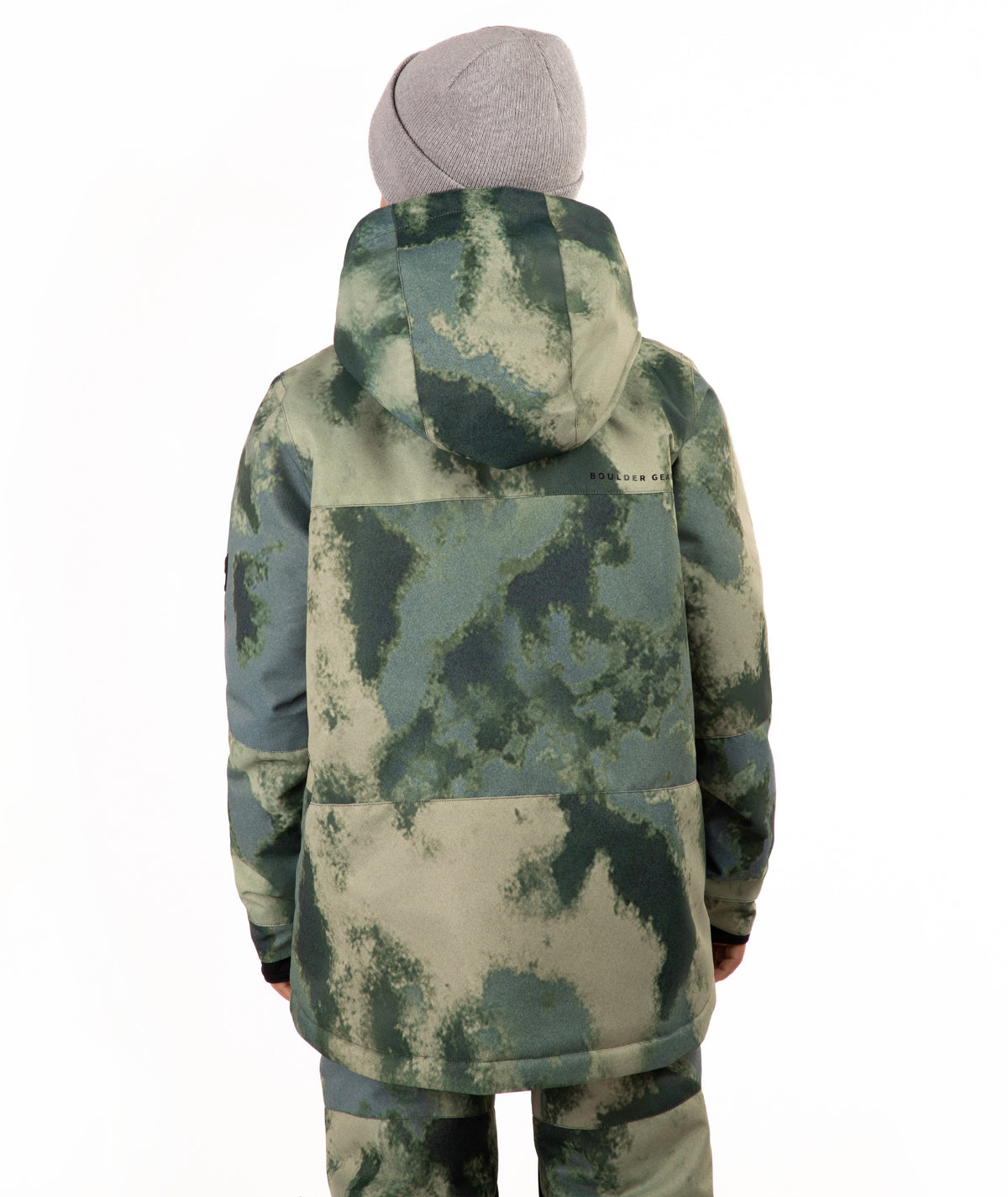 A child wearing a camouflage-patterned ski jacket and matching pants with a gray beanie, standing against a plain white background.