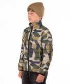 youth boy wearing a camouflage puffer jacket on a white background