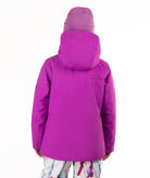 A child shown from the back wearing a bright purple hooded ski jacket and a matching purple beanie, against a plain white studio background.