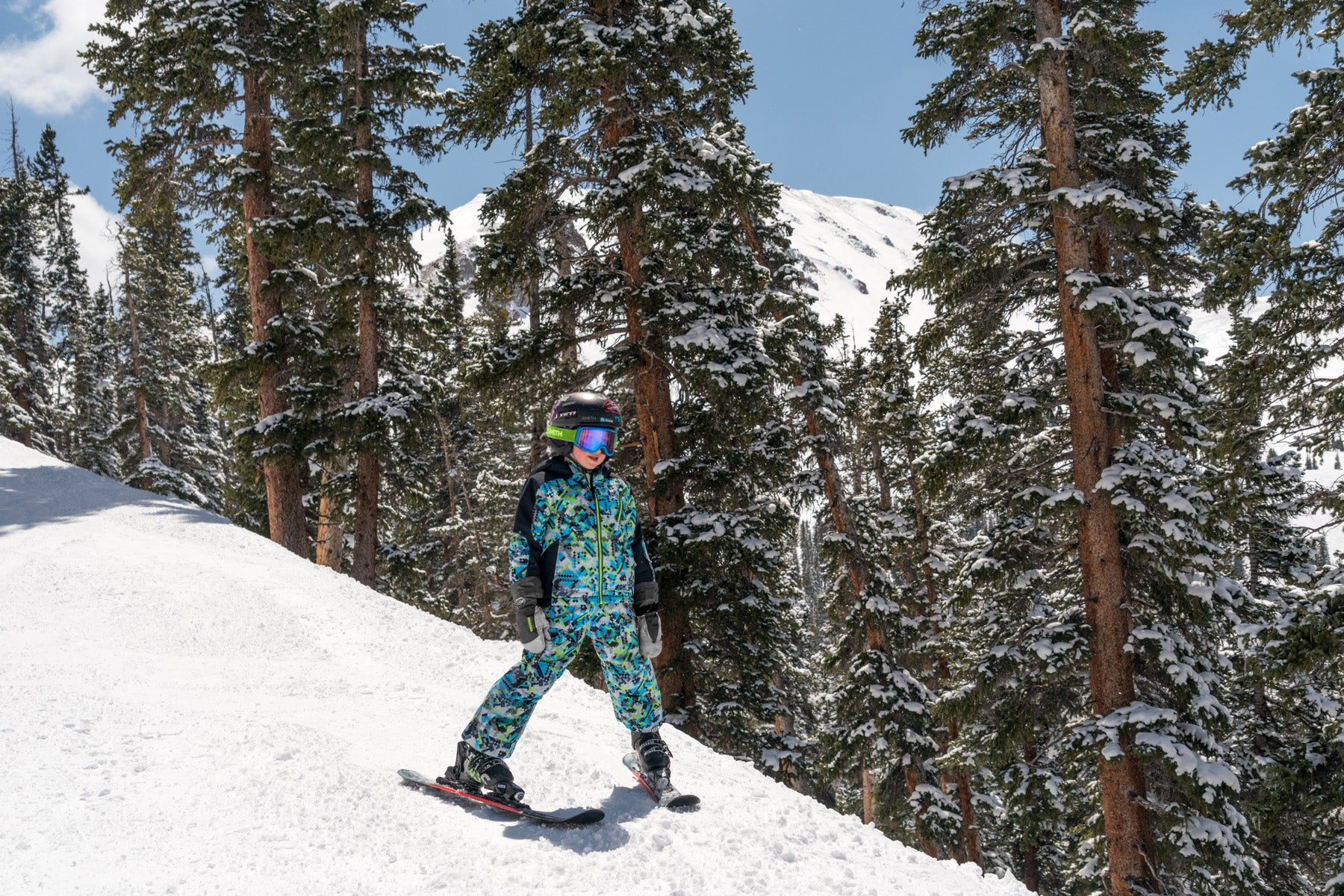 kid on mountain wearing a digital camouflage printed jacket